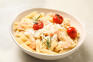 Delicious pasta with shrimps on light grey table