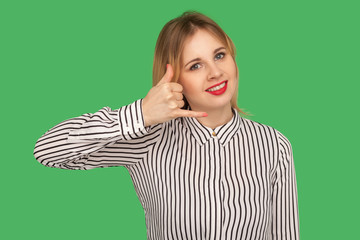Call me, let's contact by phone! Charming girl with red lips in blouse making telephone gesture...
