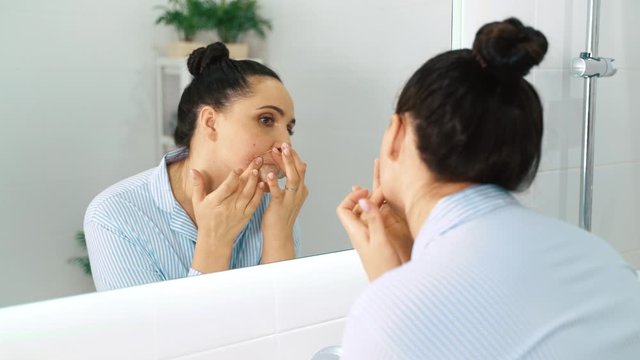 Woman removing mustache. a woman removes her mustache with wax strips