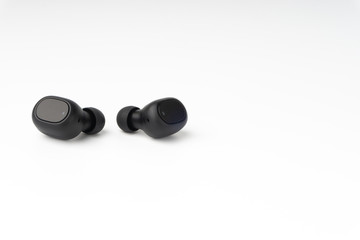Wireless earbuds or earphones on white background. Copy space and technology concept