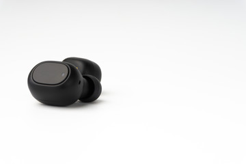Wireless earbuds or earphones on white background. Copy space and technology concept