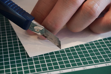 cutting paper with cutter hands finger