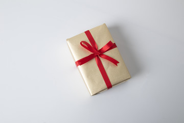 Golden gift box with red ribbon