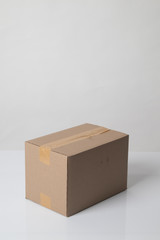 Closed cardboard box taped up ready to delivery