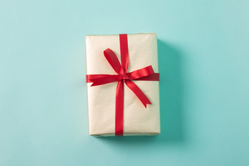 Golden gift box with red ribbon