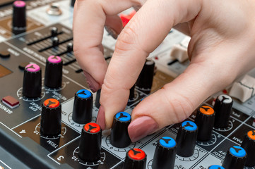 Sound engineer working on audio mixer. Close up.