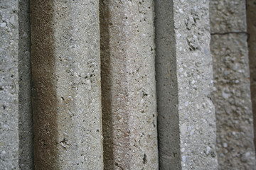 Group of concrete poles for fence. Concrete poles on selective focus