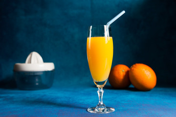 glass of orange juice and squeezer