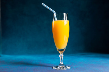 glass of orange juice with a straw