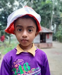 Indian village boy standby in blue dress.