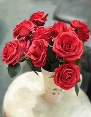 Fake flowers  for Interior.Artificial roses made by fabric and plastic use decorated.14 February is Valentine day. love wallpaper.Red roses bouquet in a vase
