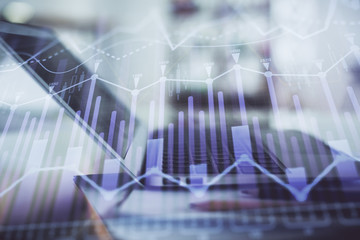 Forex graph hologram on table with computer background. Double exposure. Concept of financial markets.
