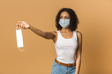 Girl tourist with a medical mask against a viral infection, coronavirus 2020. In her hands she...