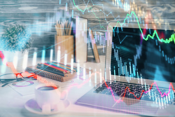 Forex market chart hologram and personal computer background. Multi exposure. Concept of investment.