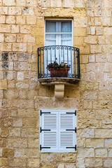 Small window and balcony with a flower pot