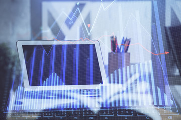 Financial graph colorful drawing and table with computer on background. Double exposure. Concept of international markets.