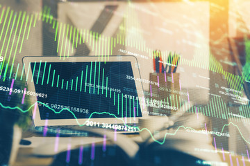 Financial graph colorful drawing and table with computer on background. Double exposure. Concept of international markets.