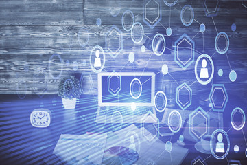 Computer on desktop with social network hologram. Multi exposure. Concept of international people connections.