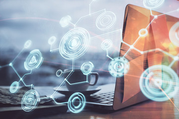 Computer on desktop with social network hologram. Multi exposure. Concept of international people connections.