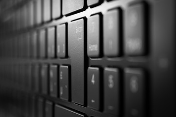 Vertical view of laptop keyboard with selective focus and soft background blur