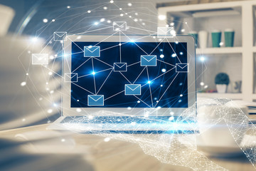 Desktop computer background in office and flying envelops hologram drawing. Multi exposure. Electronic mail concept.