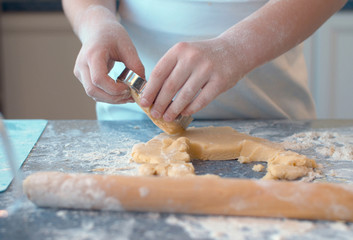 Girl making cookies with a cookie cutter