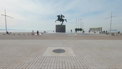 Alexander The Great statue on Bucephalus horse at the city waterfront hyperlapse. Day view of six meters tall monument and surrounding area at Thessaloniki, Greece.