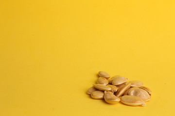 pumpkin seeds on color background