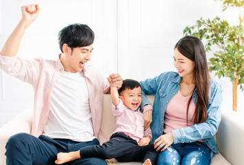 happy Family playing and  sitting on the sofa in the living room