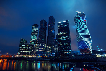 Obraz premium High modern skyscrapers of Moscow city with lighting and reflection in the river