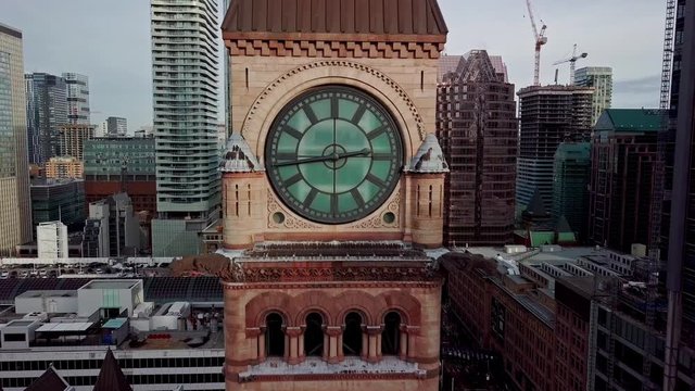The beautiful, red clock tower standing out in the Nathan Phillips Square, Canada - aerial