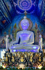 Obraz premium white Buddha statue at unique Blue Temple (Wat Rong Suea Ten). All the drawings and sculptures of all shades of blue. Chiang Rai, Thailand