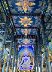 white Buddha statue at unique Blue Temple (Wat Rong Suea Ten). All the drawings and sculptures of all shades of blue. Chiang Rai, Thailand