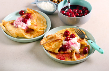 Thin pancakes with yogurt and cherry