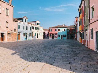 Fototapeta na wymiar BURANO, ITALY - JANUARY 20, 2020: Colorful houses on the island of Burano in Italy. Burano island is famous for its colorful fisherman's houses..