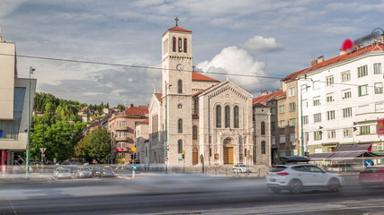 City traffic and people on the cross walk in front of Saint Joseph's Church on Titova street timelapse hyperlapse in Sarajevo, Bosnia