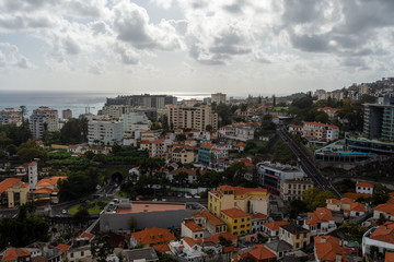City of Funchal town on Madeira Portugal with horizon and a cloudy sky in background