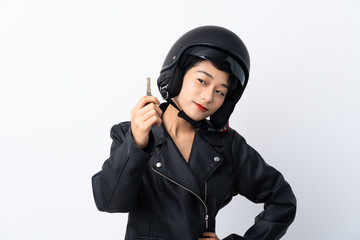 Young Asian girl with a motorcycle helmet and a key over isolated white background