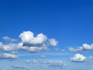 Blue sky with a few white clouds. Beautiful bright sky background. Clear day and good clam weather