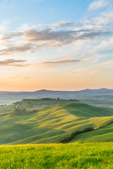 Sunrise in a rolling rural landscape