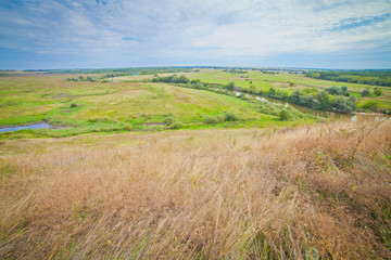summer landscape with large meadows and blue sky and open space