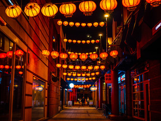 Traditional Chinese lanterns in the night. Looking down a street in China town. 