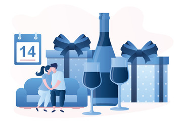 Love couple sitting on the couch and kissing. Gifts, Bottle and two glasses on background. People celebrate Valentine's Day