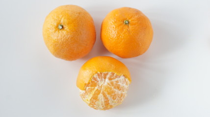 Tangerines in the skin and peeled