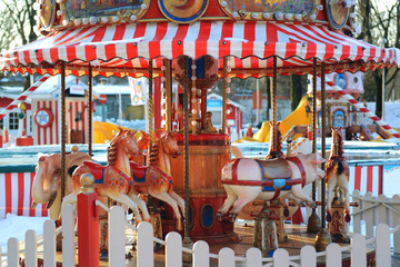 Horses carousel at the amusement entertainment park. Colorful carousel with horses, amusement park element. entertainment, merry-go-round, funfair carnival. Colorful swing ride Horse merry-go-round