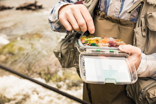 Close-up of fly fisherman holding a fly box. Red Lodge, Montana, USA