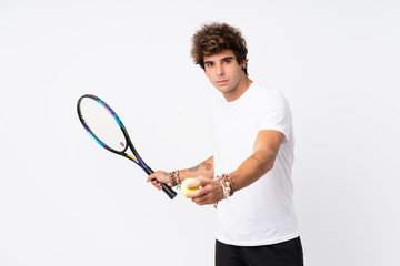 Young caucasian man over isolated white background playing tennis