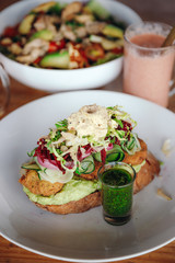 vegetarian lunch with falafel and green sauce. smoothies in the background