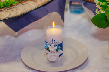Beautiful candles on the table for the newlyweds on their wedding day.