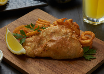 Steak fried fish fingers serve with fries and half fruit lemon. Serve with sour cream.